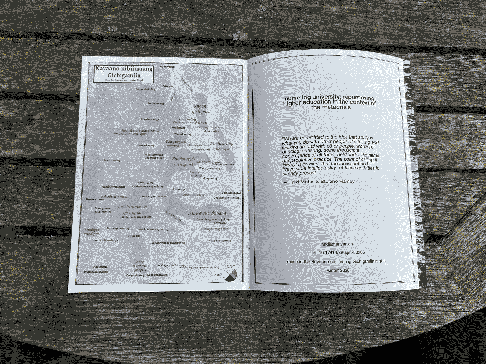 image of the zine open to it's first page sitting on an outdoor table